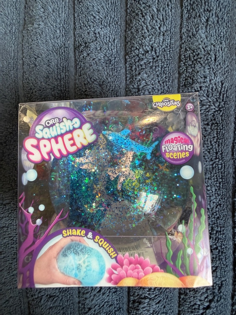 ORB Squish-o Sphere Glitter Sensory Ball - clear with blue glitter